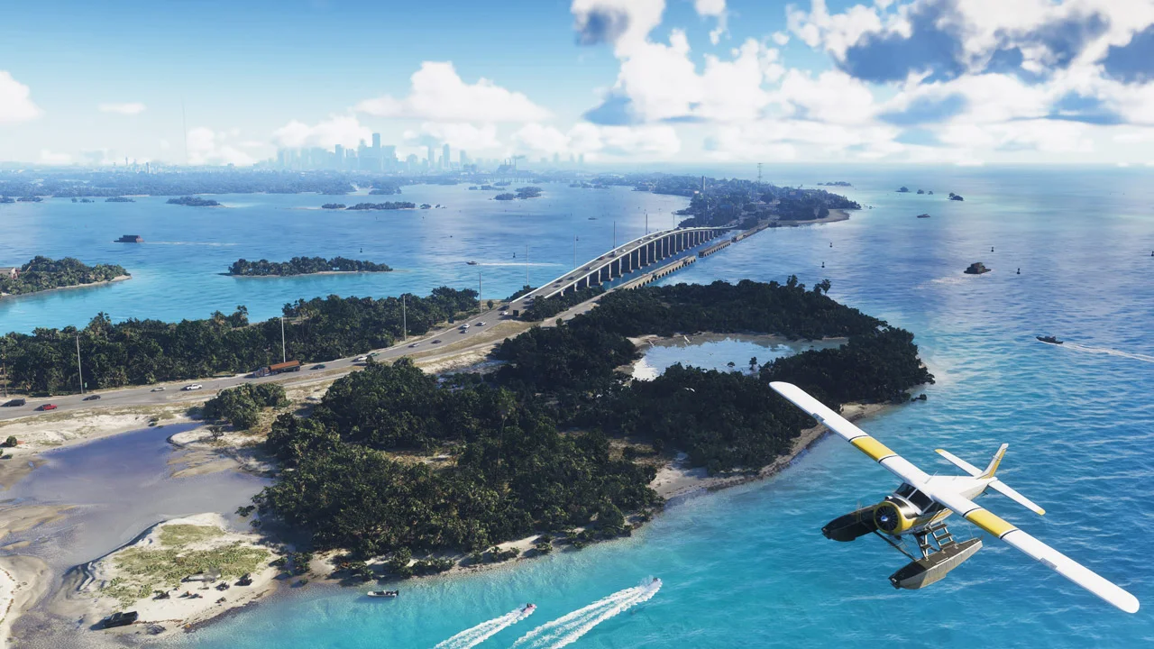A seaplane above islands and a long bridge, with a coastal skyline in the distance.